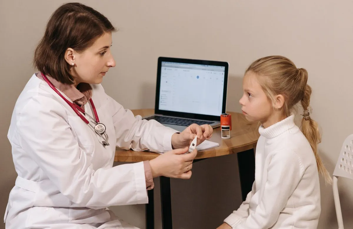 Stock photograph of a doctor consulting with a child